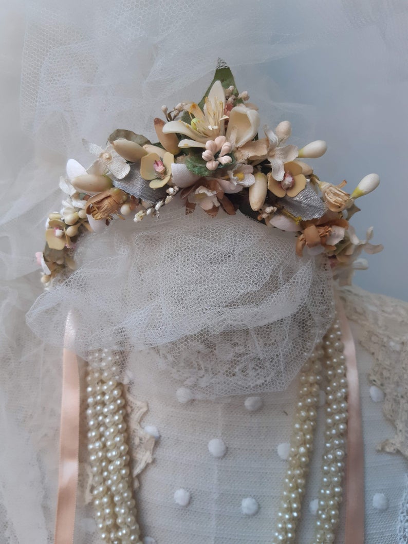 A blush pink handmade bridal headdress hand crafted with antique and vintage flowers and leaves